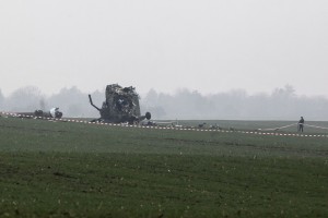 A Serbian army soldier stands next to the wreckage of a military helicopter near Belgrade airport